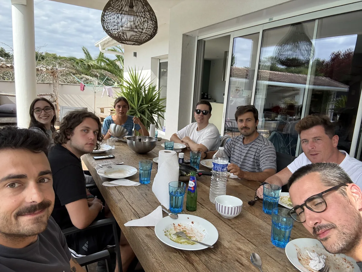 The Resizes team gathered around a long outdoor table for lunch.