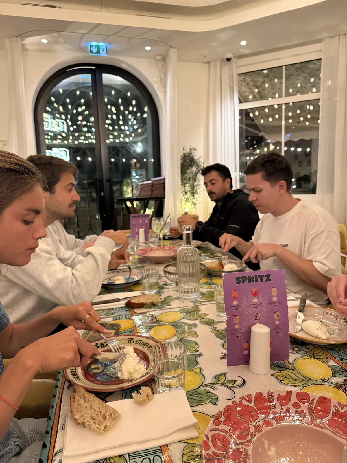 Teammates sharing dinner around a colourful restaurant table.